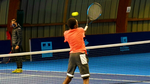 Un jouuer de tennis frappe dans une balle